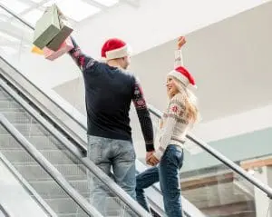 Two people celebrating Christmas shopping.