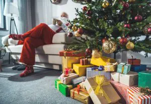 Santa resting and learning about the history of Christmas trees