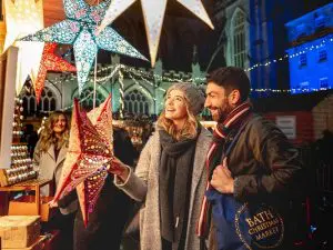 A gleeful couple enjoying Bath Christmas market