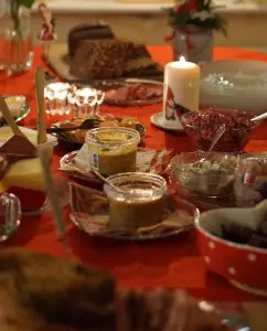 Pic of a Christmas dinner table with lots of side dishes for diners