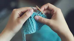 Pic of a woman knitting - learn How to make your own Christmas gifts this year