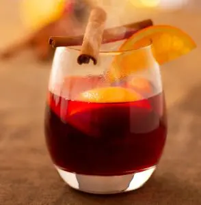 pic of a glass of mulled wine with fruit - Mulled wine at Christmas – recipes and history